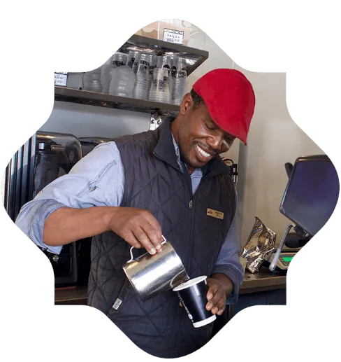 Barista preparing coffee behind the counter