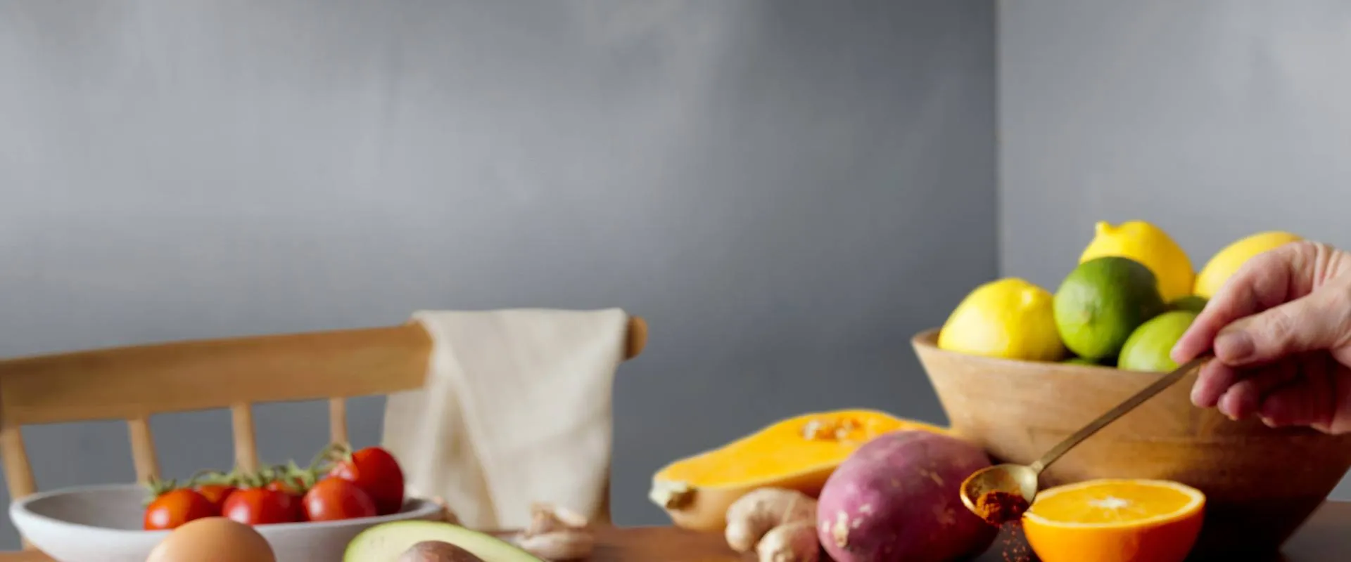 spice being sprinkled over food with fruit in background
