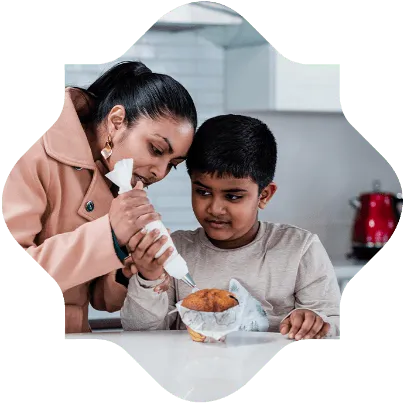 Arman with his mom decorating cakes