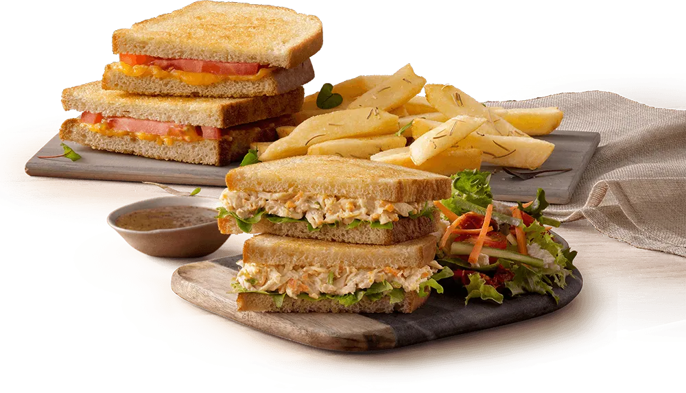Satay Beef & Noodle Salad Toasted sandwiches with chips on a wooden board