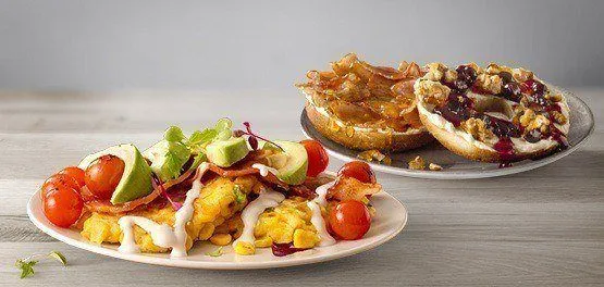 Two brunch meals depicted on a grey background