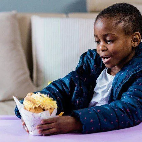 Takatso holding a muffin