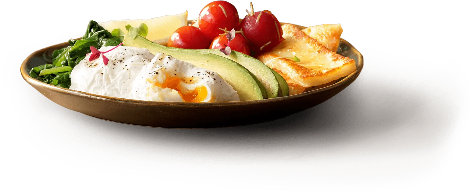 Low-carb breakfast plate with eggs, avocado, bacon, tomatoes, and spinach Low-carb breakfast plate with eggs, avocado, bacon, tomatoes, and spinach