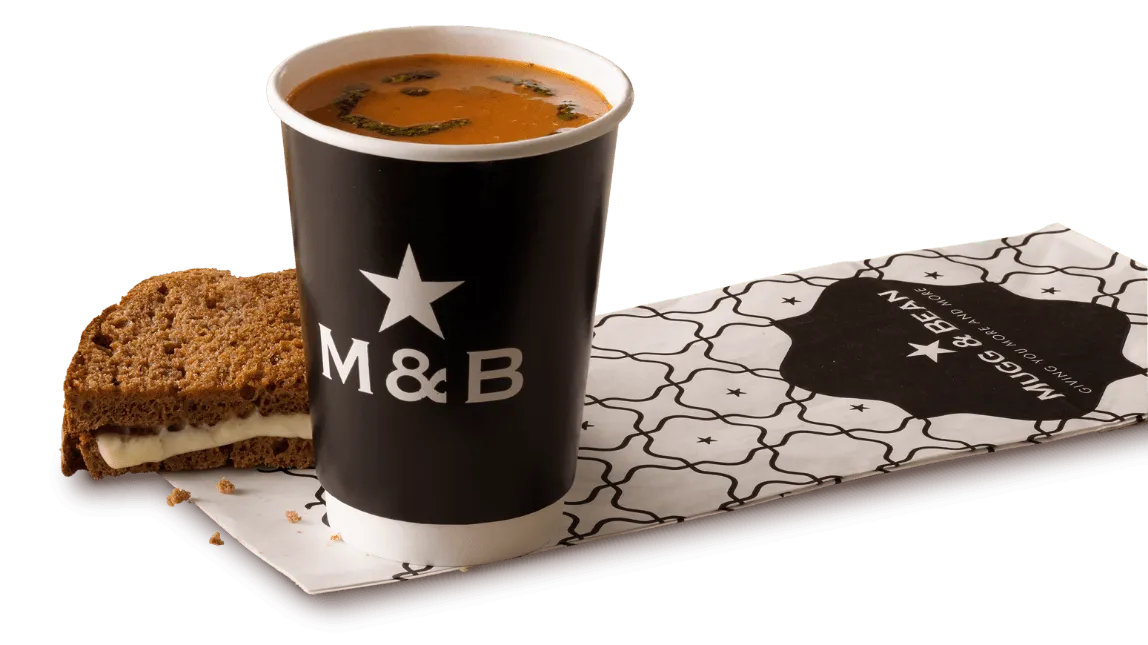Soup in a takeaway cup with toasted cheese
