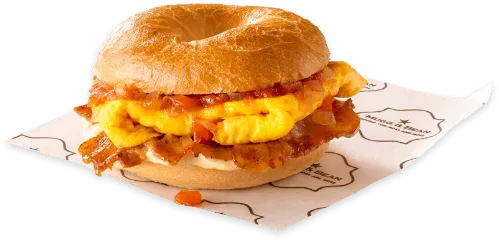 A bagel with scrambled eggs, and bacon