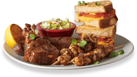 A South African grill platter with meat skewers and sausage