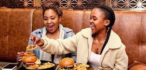 two brunette women enjoying lunch at Mugg and Bean