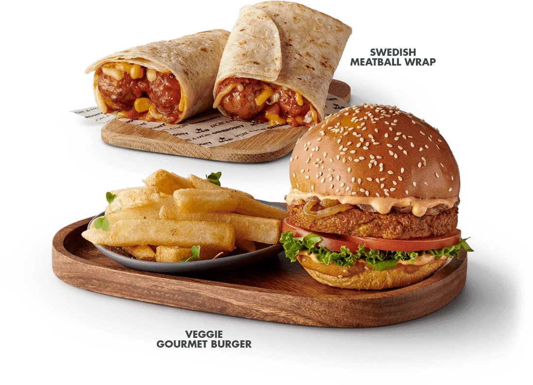 The Veggie burger with a side of chips, served on a wooden board with a  wrap in the background