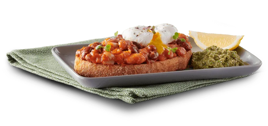 Beans on Toast on a plate on a white background Beans on Toast on a plate on a white background