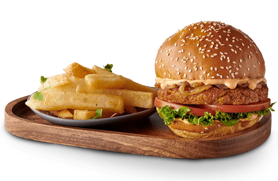 Plant based burger with a side of chips on a wooden serving board Plant based burger with a side of chips on a wooden serving board
