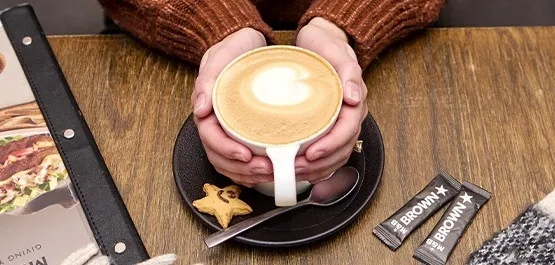 A steaming cup of Mugg & Bean takeout coffee, perfect for those chilly mornings.