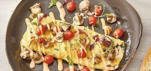 Omelette with tomato and drizzle of sauce