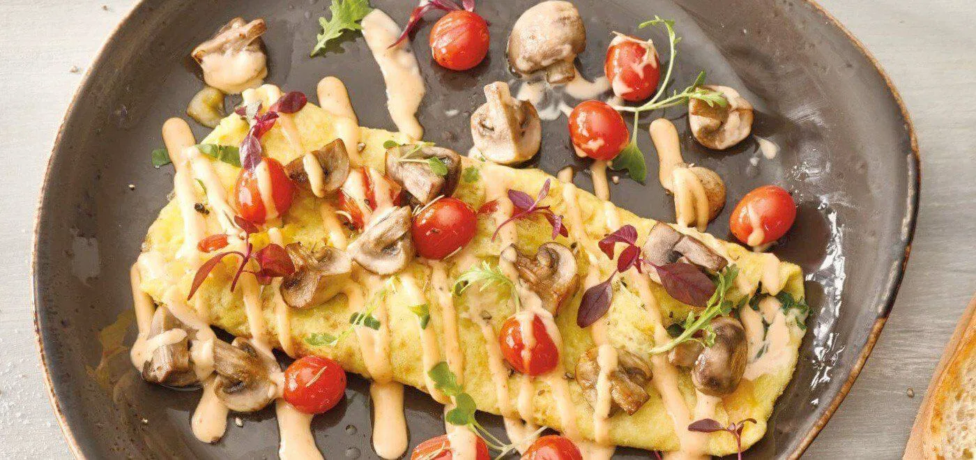 omelette with tomato and drizzle of sauce omelette with tomato and drizzle of sauce