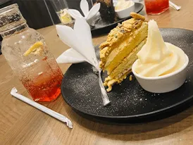 Slice of tart with ice cream and craft lemonade