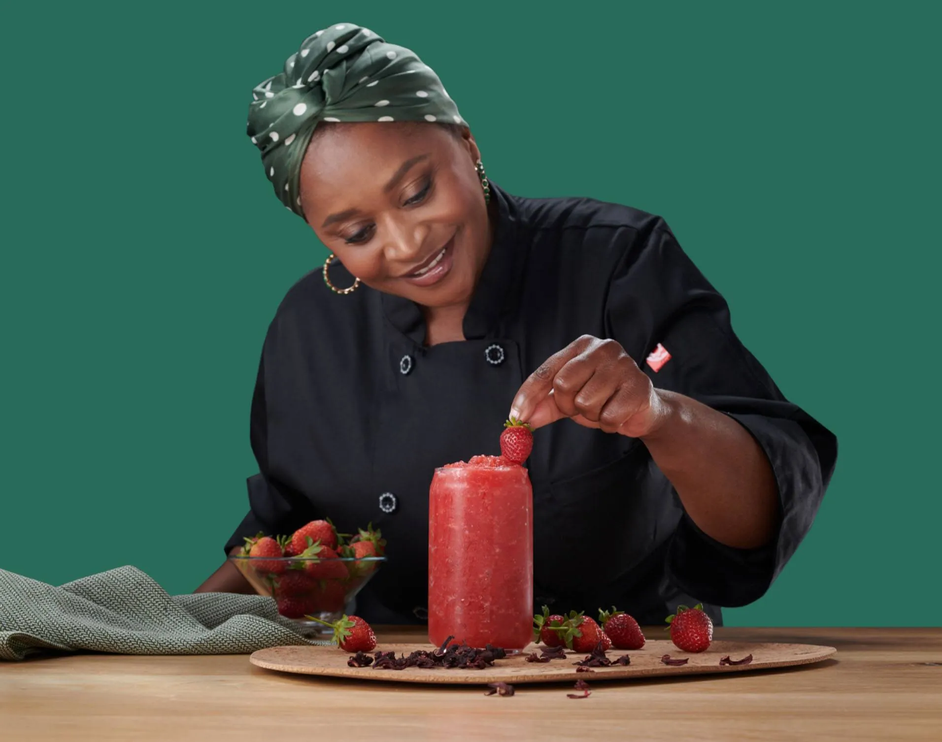 chef mokgadi holding a strawberry with a drink