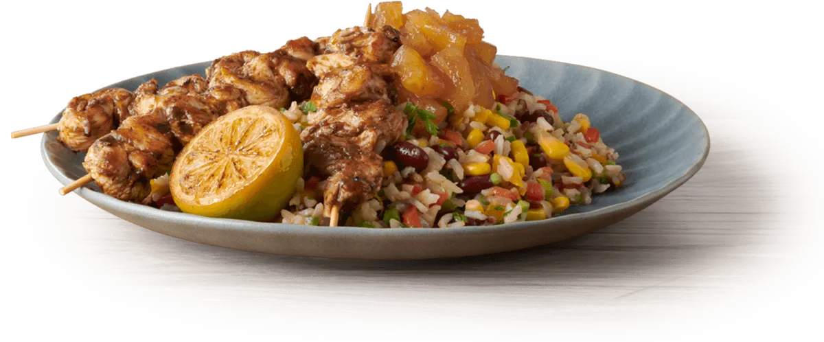 bowl with jerk chicken and salad