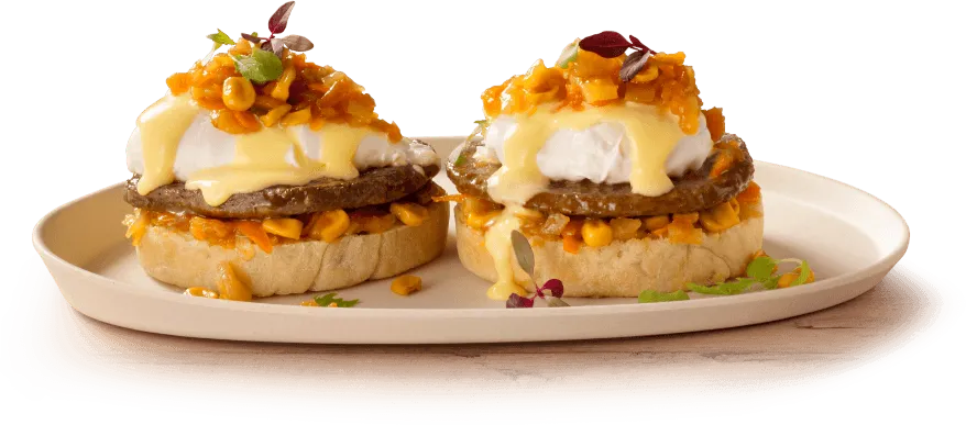 Two slices of toast topped with avocado and poached eggs Two slices of toast topped with avocado and poached eggs