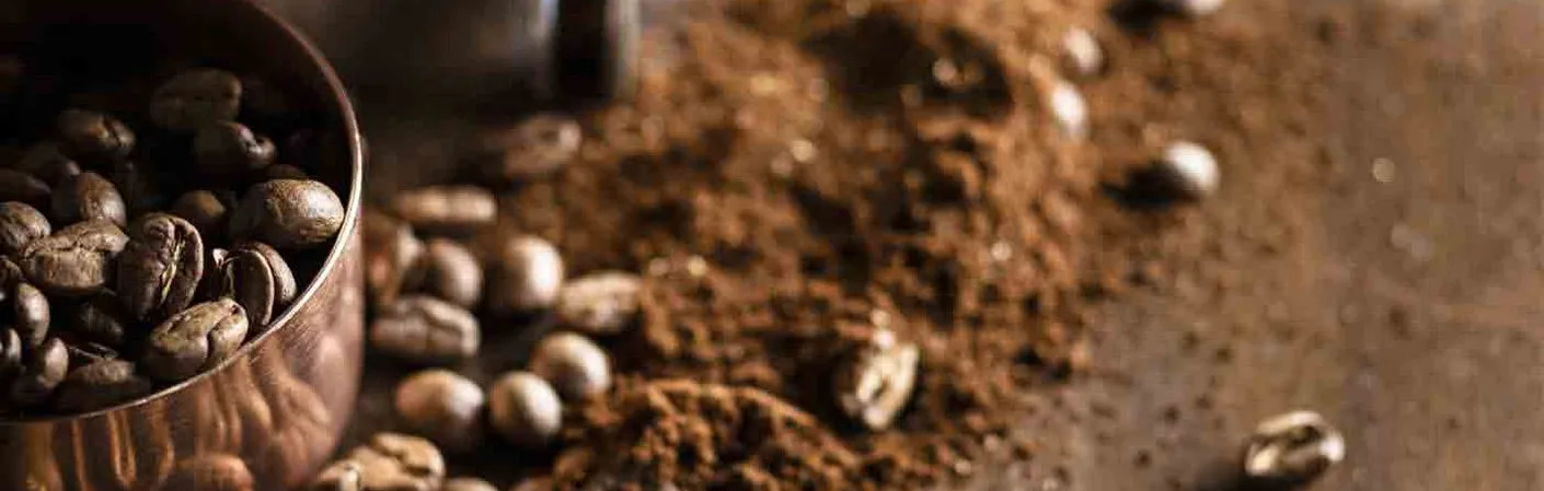 coffee beans and some coffee grounds coffee beans and some coffee grounds