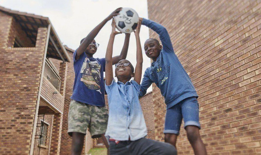 Chinedu playing ball with his friends
