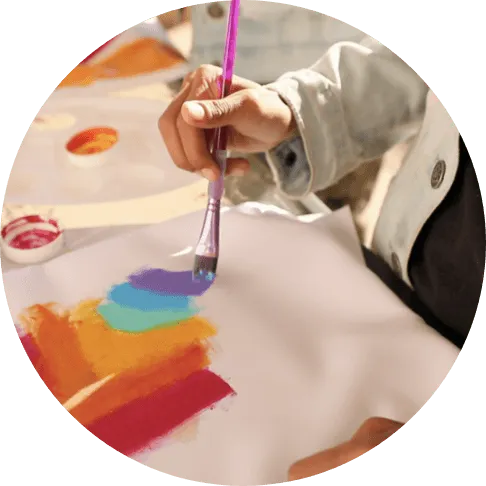 Nikita painting a rainbow
