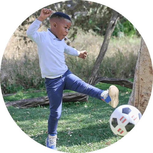 Mhlengi playing with a soccer ball