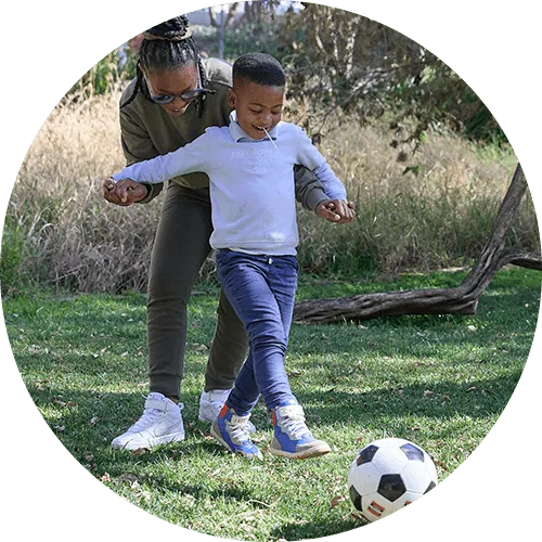 Mhlengi playing with a soccer ball