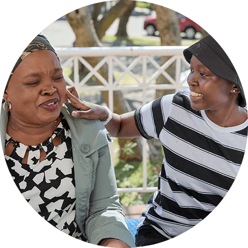 Mpho eating cupcakes with mom outside