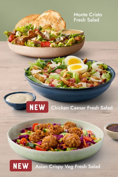 Two fresh salads — Monte Cristo Fresh Salad and new Asian Crispy Veg Fresh Salad — served in bowls with a side of dressing.