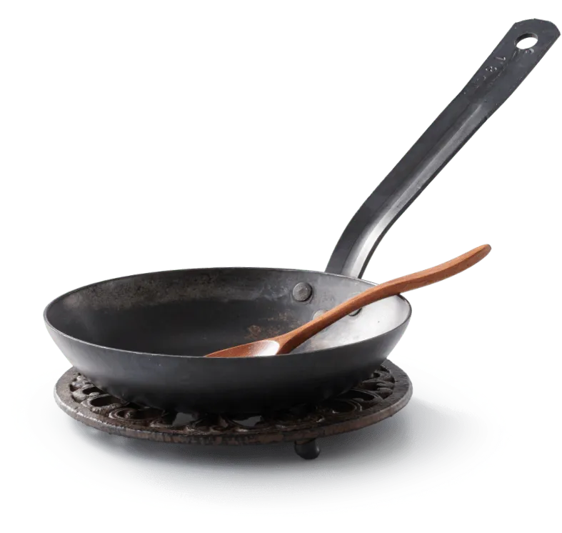 A frying pan with wooden spoon