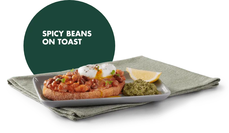 Spicy beans on toast with a poached egg on a plate