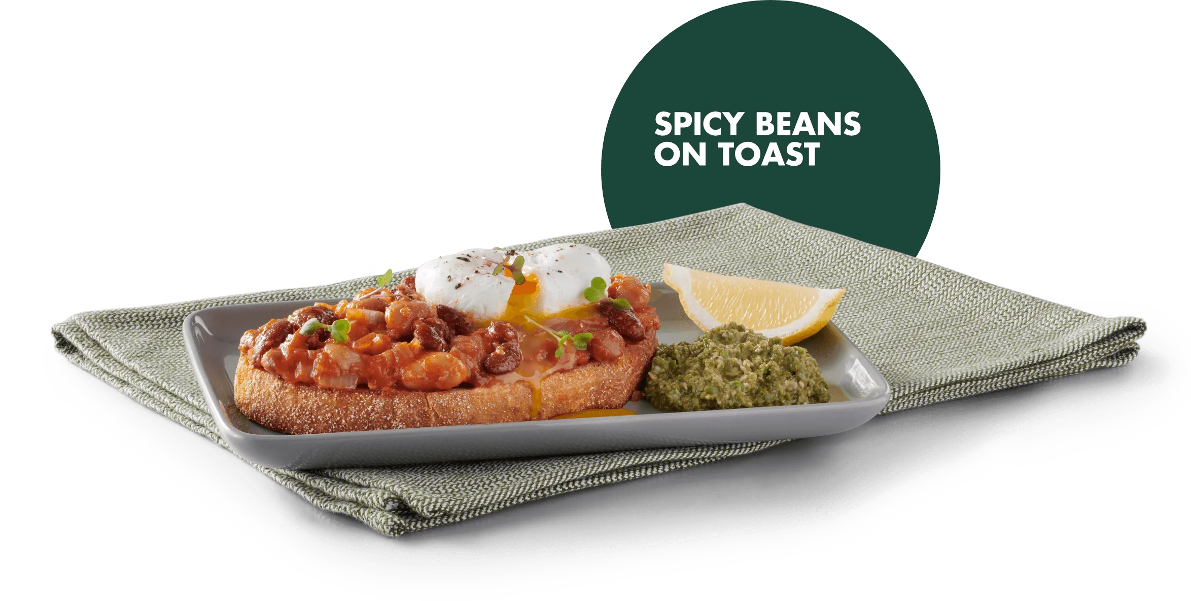 Spicy beans on toast with a poached egg on a plate