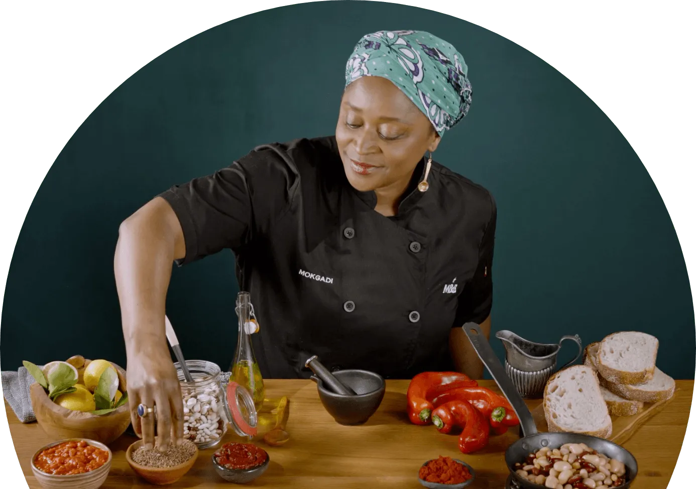 Chef Mokgadi grabbing spices from a bowl